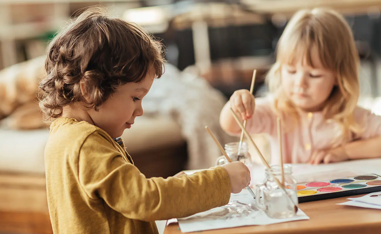 Enfants peignant autour de la table